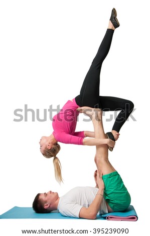 Man and woman doing acro yoga or yoga with partner on a white background