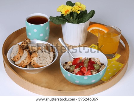 Healthy breakfast: cereals with fresh fruits, wholemeal bread, tea and fresh orange juice