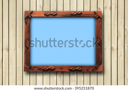 wooden picture frame with clipping path hanging on wall