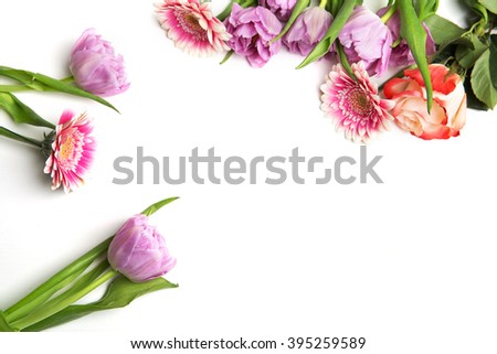 Frame from flowers on a white table. Selective focus. Place for text.
