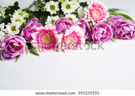 Frame from flowers on a white table. Selective focus. Place for text.
