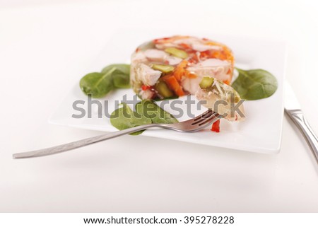 Jelly with meat turkey with vegetables on a white background.
