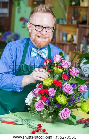 Single handsome man creating a flower arrangement