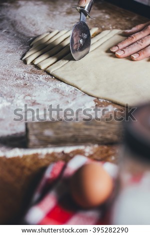 Woman making pasta from dough