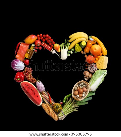 Deluxe Heart symbol. Studio photography of heart made from different fruits and vegetables on black background. High resolution product.
