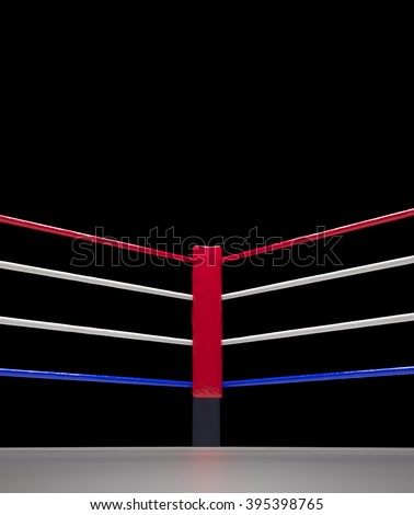 close up of the red corner boxing ring surrounded by ropes isolated on dark background with clipping path