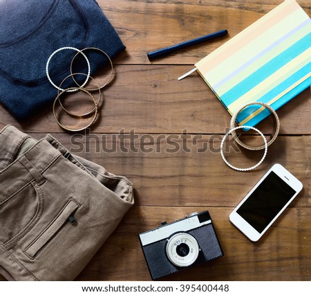 flat lay hipster clothes on wooden parquet. Fashion, design background. Text space