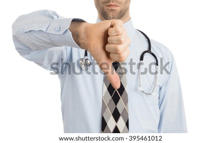 Caucasian male doctor making a dislike gesture keeping thumb down