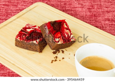 chocolate covered strawberry brownies with coffee on wood.
