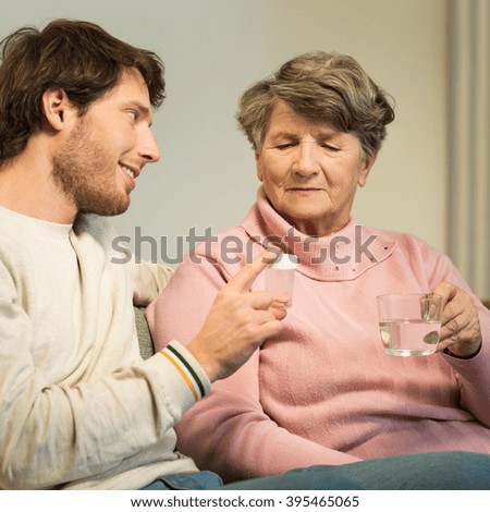 Senior woman and caring grandson at home