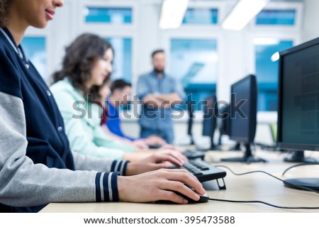Cropped picture of students using computers in a classroom