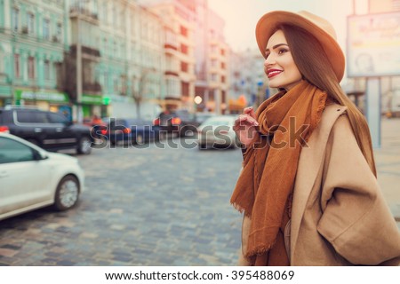 Happy young pretty woman with hat walking down the street. Vacation Europe