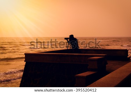 Silhouette photographer takes a good shot on the Huahin beach, Prachuap Khiri Khan, Thailand