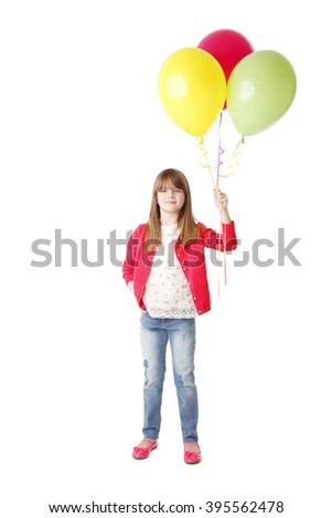 Full length portrait of happy little girl holding in her hand balloons while standing at isolated white background.