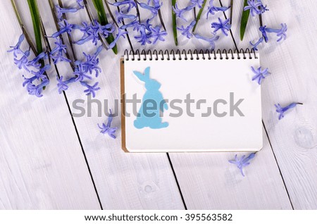 Spring flowers on the table with a notebook for notes, Easter card