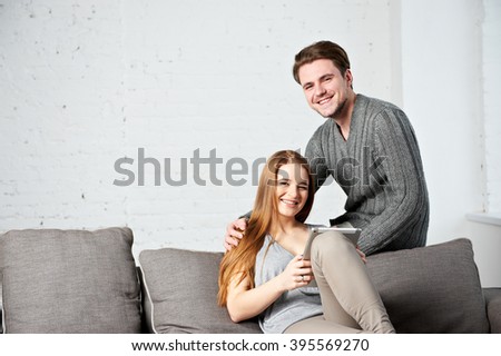 Young couple watching photos on internet with tablet