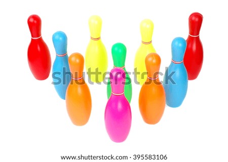 Row of colorful toy plastic bowling pins isolated on white background