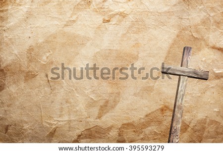 Old brown wooden cross, with sun flash on grunge background