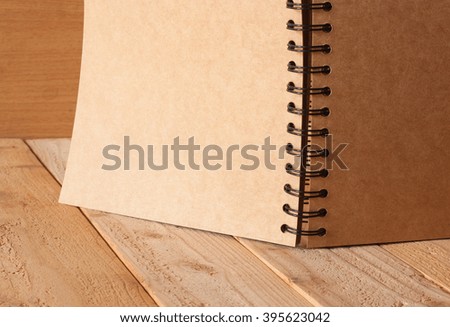 Open blank note book on wood background