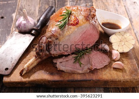 grilled lamb leg on board Royalty-Free Stock Photo #395623291