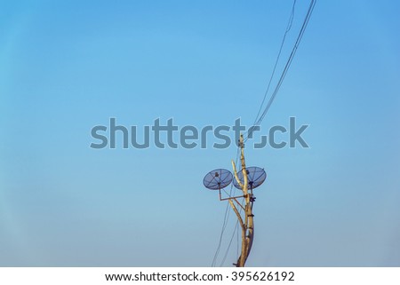satellite dish and Installed on an old power pole with blue sky background