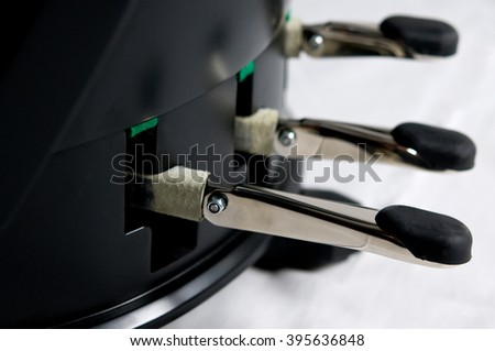Close up image of three pedals on a pedal harp, selective focus on foreground.
 Royalty-Free Stock Photo #395636848