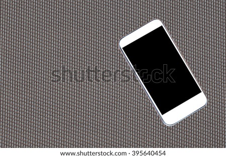 modern touch screen smartphone on texture background  copy space