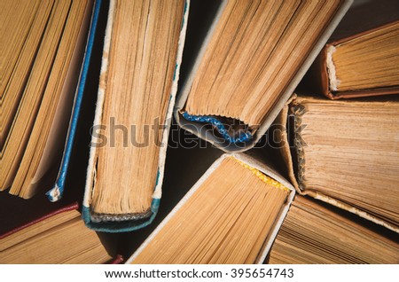 Old and used hardback books or text books seen from above.