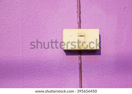 Old switch on the purple wall