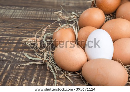 Fresh Egg and duck eggs on wooden background.
