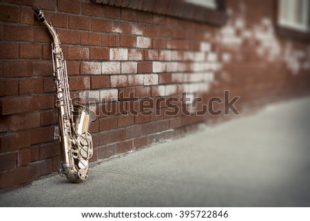 Jazz musical instrument saxophone with grungy street background
