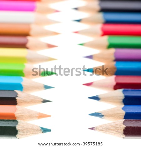 Line of colour pencils isolated on white with shallow depth of field