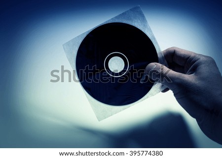 Hand holding a CD , DVD disk,  technology concept.