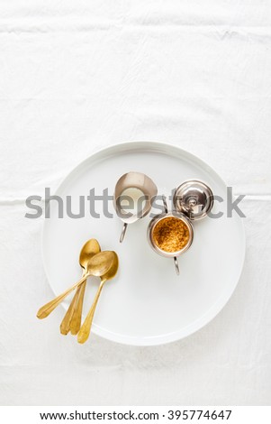 silver vintage set for coffee or tea. sugar bowl, milk jug and golden spoons