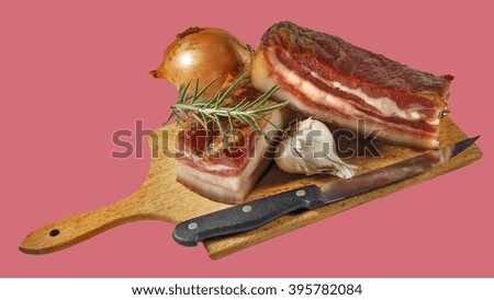 Bacon with garlic and knife on wood cutting.                               