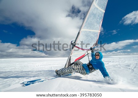 Man riding a surf and skiing. Day with clouds. Extreme winter sport Royalty-Free Stock Photo #395783050
