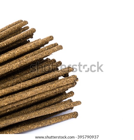 Close-up a bunch of incense sticks isolated on white. Incense use in religious ritual.Its burned to intend as a sacrificial offering to various deity or to serve as an aid in prayer. Copy space.