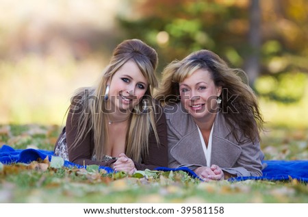 Mother and daughter enjoying a sunny autumn day in the park
