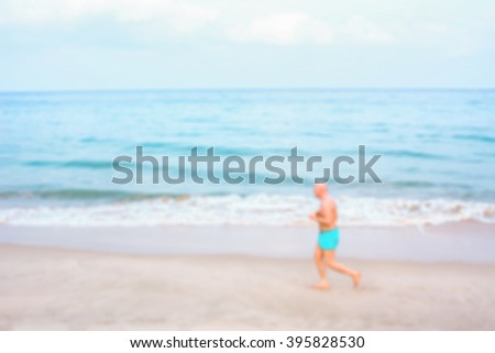 Exercise runner on the beach. Blur photo