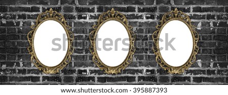 vintage golden frames with copy space hanging on the dirty brick wall