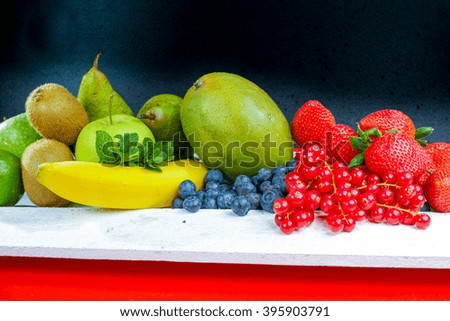 Variety fresh organic red and blue berry, strawberry, mango and  green fruits, copy space