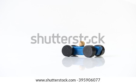 Blue wooden toy race car with black tyre. Isolated on white background. Slightly de-focused and close-up shot. Copy space.
