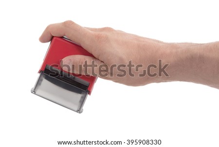 Plastic stamp in hand, isolated on white