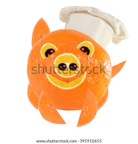 Creative food concept. Little Chef is a funny pig made from oranges.