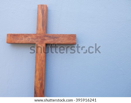 wooden cross on gray background.