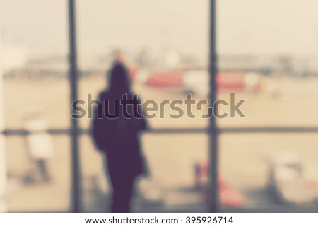 blurred background - blur airport terminal and passenger looking on