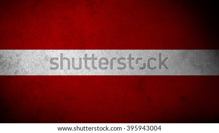 Latvia flag on a dark concrete surface