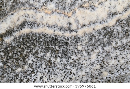 Closeup abstract background texture photo of marble stone slab with hollows and natural yellow limestone pattern
