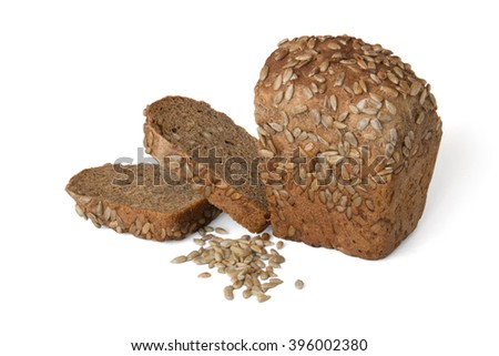Brown bread with sunflower seeds and two slices isolated on white background