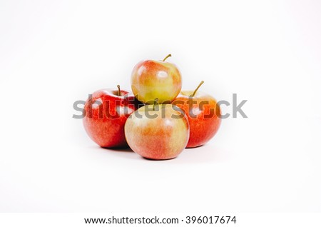 Red apples are grouped on a white background. pair number